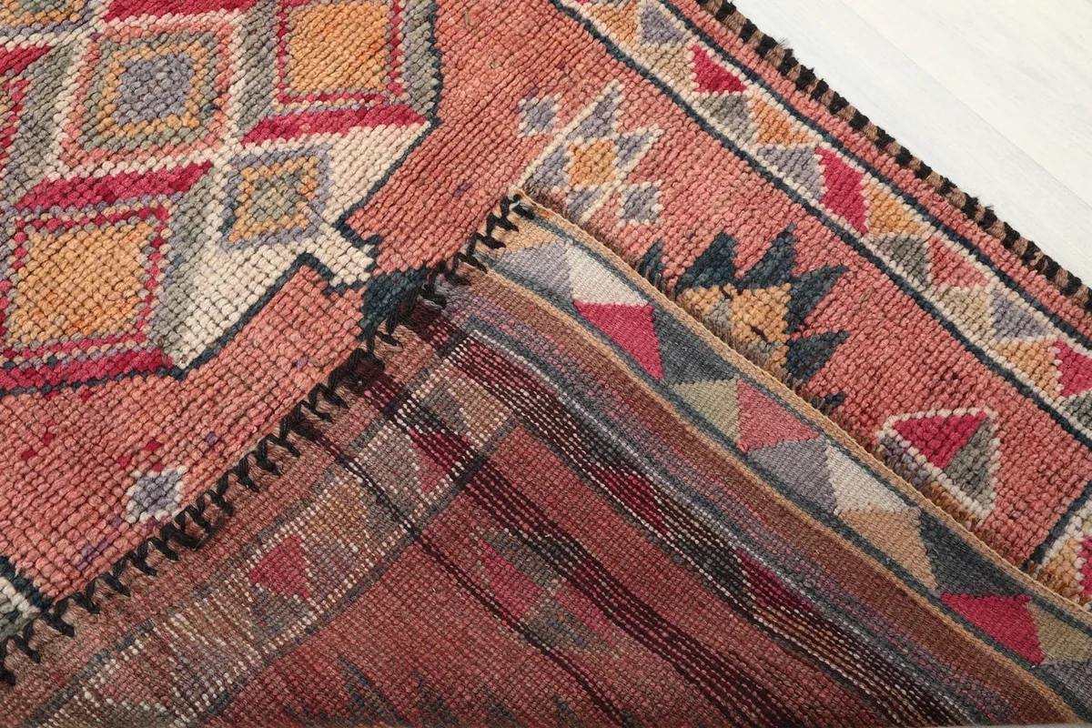 View of the back of the hand-knotted rug, revealing its cotton foundation