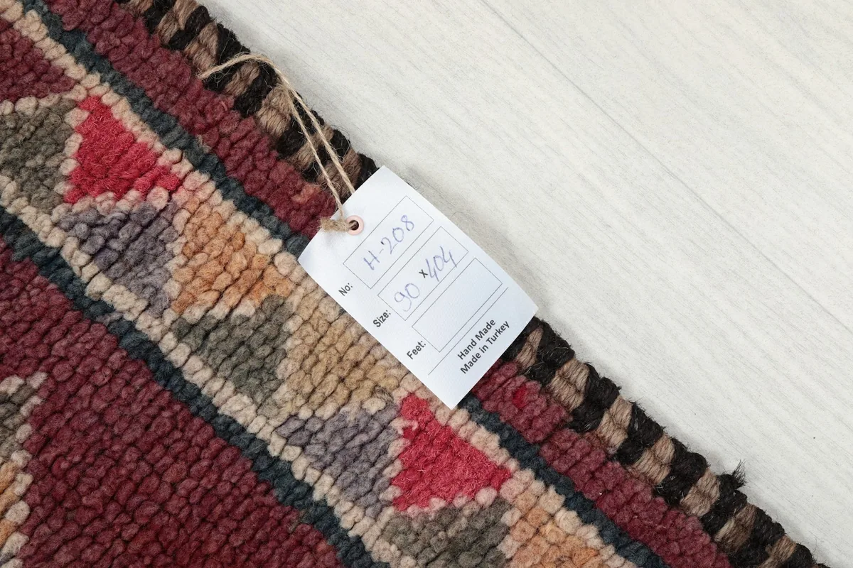 Tag showing the rug's dimensions and origin, attached to the rug's edge