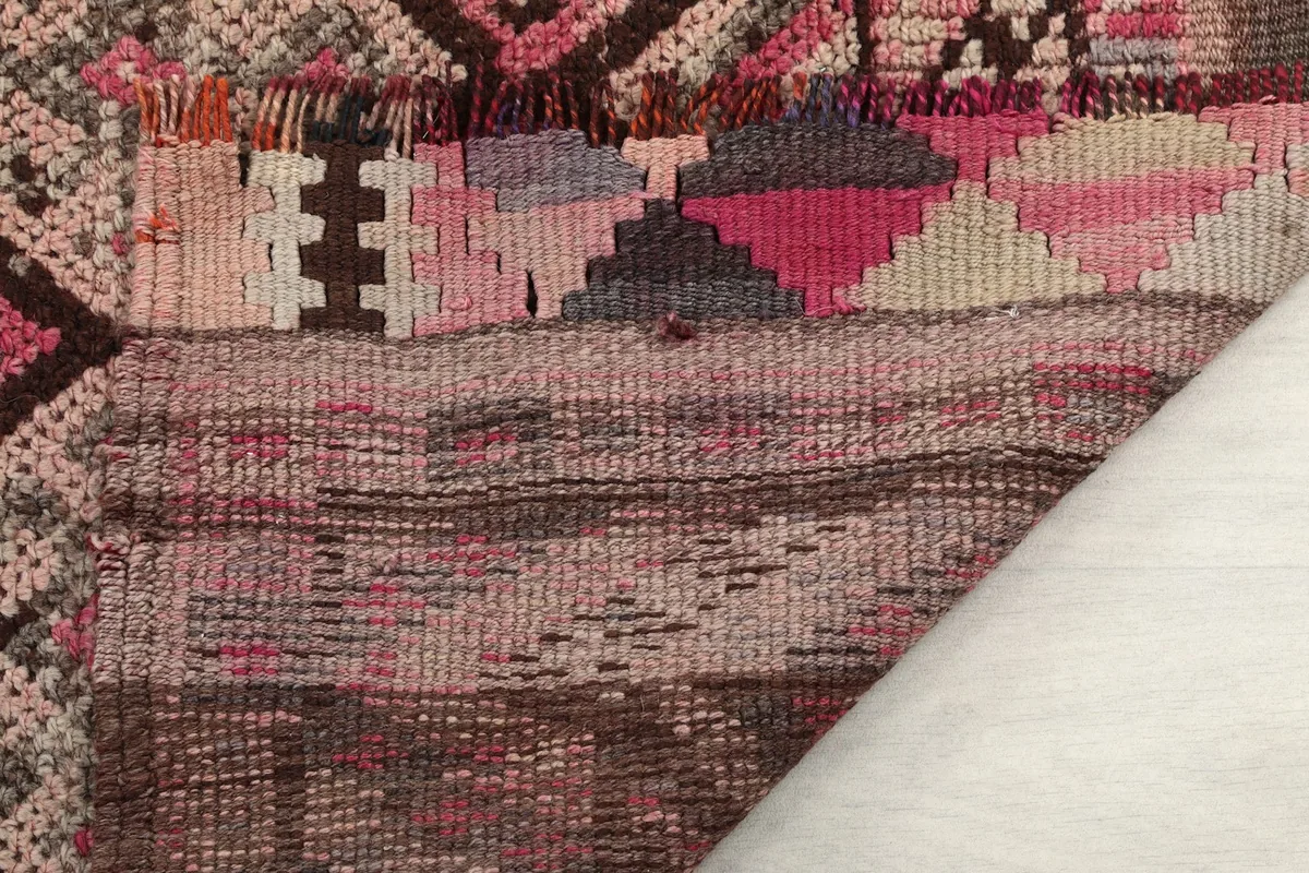Close-up of the rug's low pile and the tightly woven wool on cotton foundation.