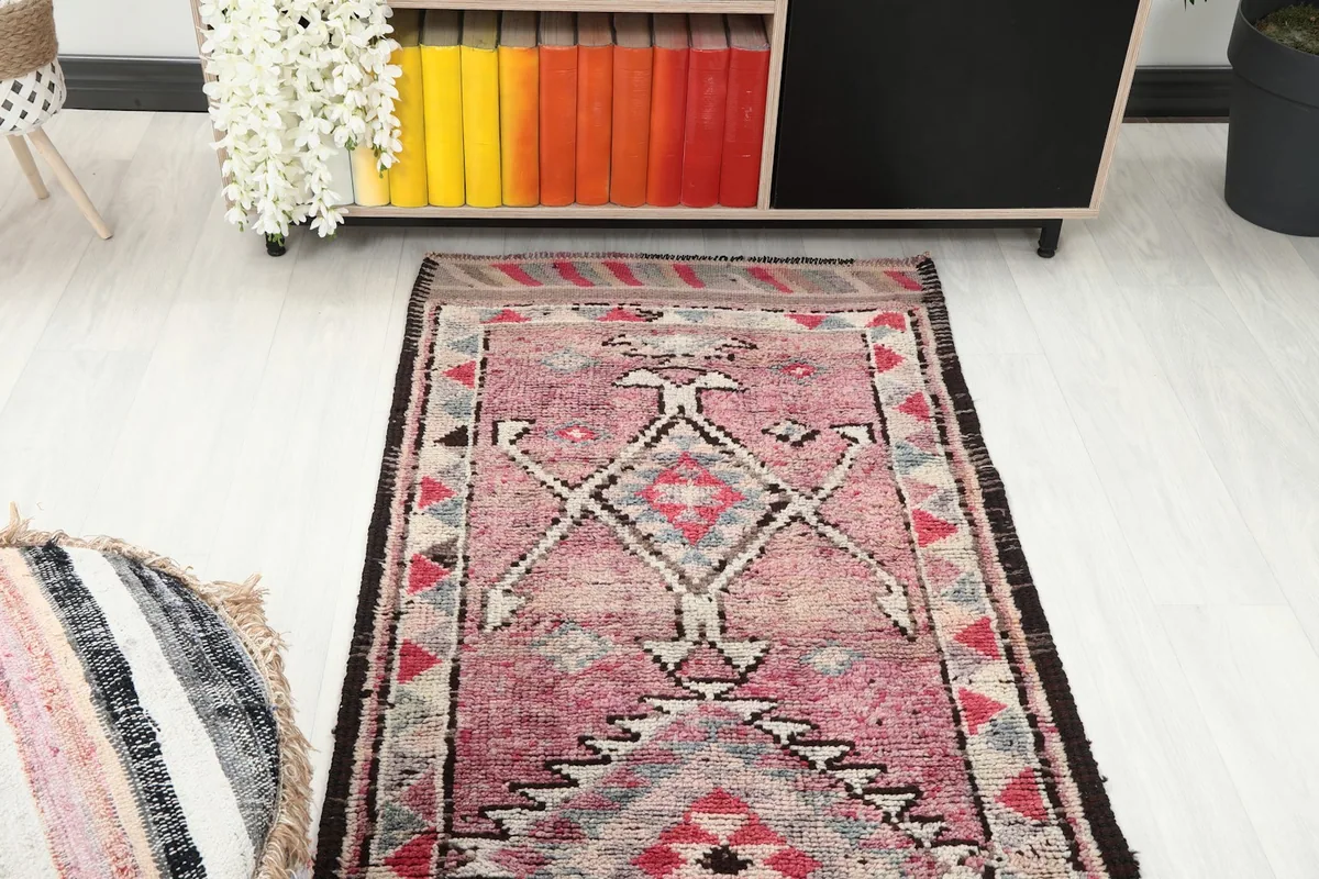 Overhead angle view of one end of the runner rug, showing the geometric patterns and border