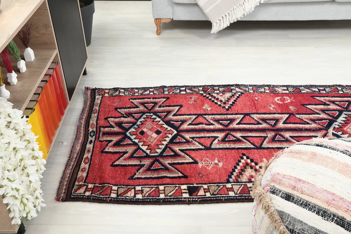 Angled view of the runner rug in a room, showing its length and how it complements the surrounding decor.