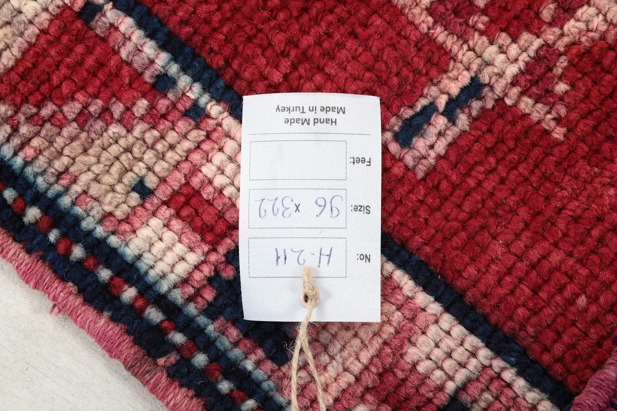 Close-up of the rug's back with a product tag displaying size and origin information.