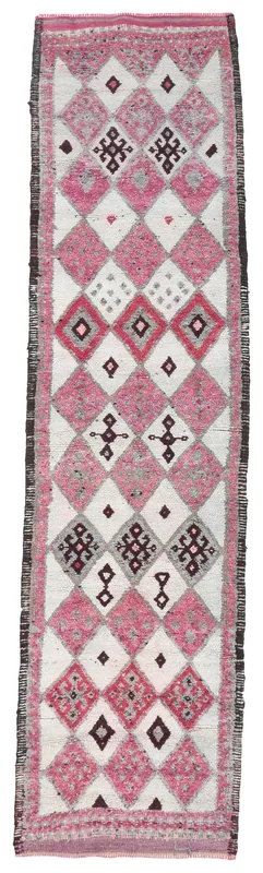 Full overhead view of the pink and ivory geometric Anatolian runner on a white background.