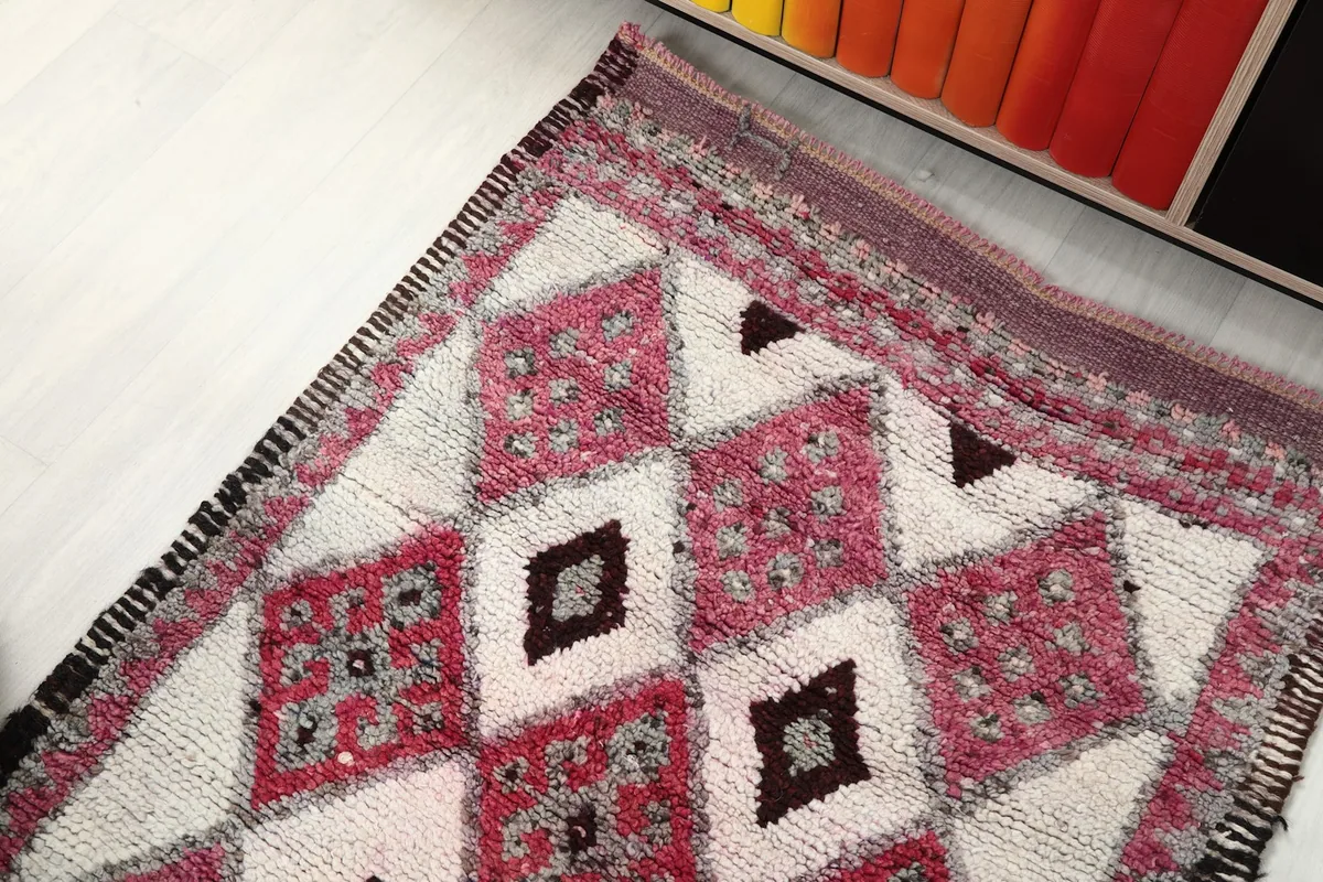 Angled shot highlighting the texture and color variations in the vintage runner's design.