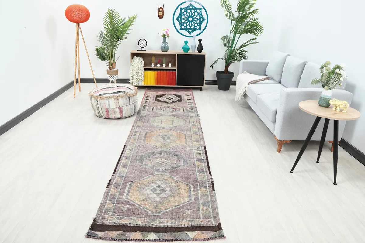 Purple vintage runner rug displayed in a bright living room setting