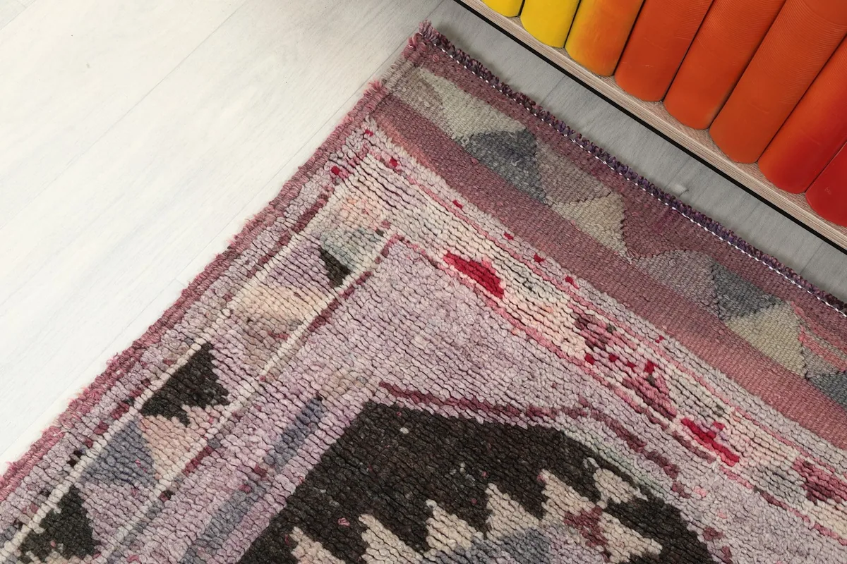 Corner detail of the rug showing the edge and geometric border design