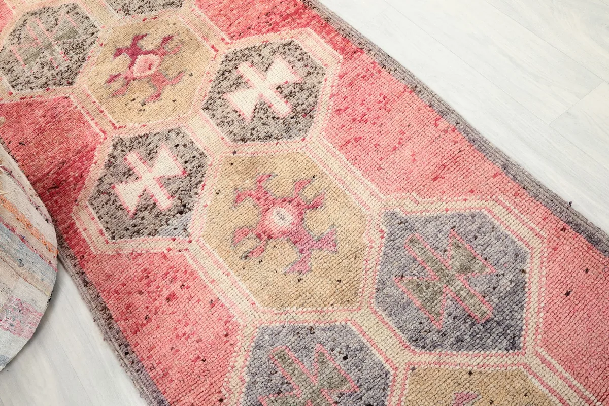 Overhead angled view of the runner rug highlighting the sequence of geometric medallions