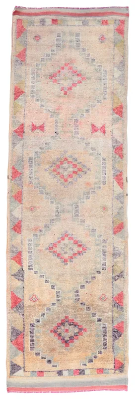 Full overhead view of the beige and rose vintage Anatolian runner rug with geometric patterns.