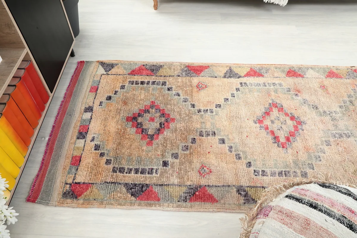 Side angle of the runner rug, capturing the full length of its pattern and color variations.