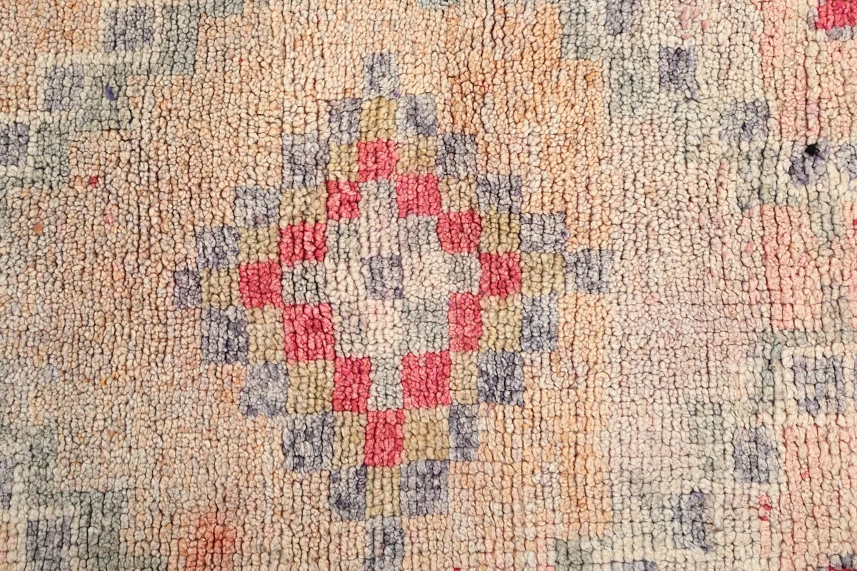 Detailed view of the intricate rose and gray checkerboard pattern within a geometric motif.