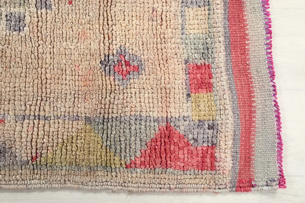 Detail showing the low wool pile and hand-knotted texture of the vintage rug.