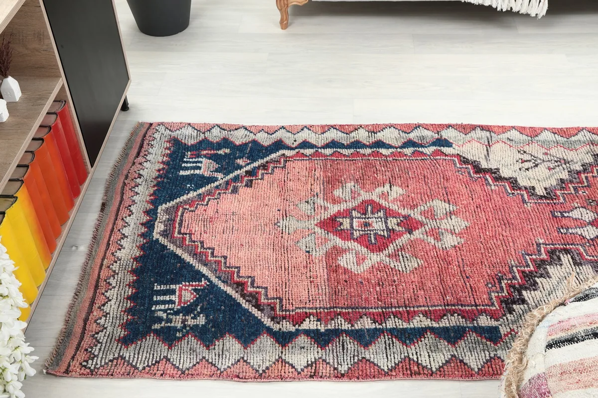 The rose runner rug extending through a room, showcasing its length and vibrant colors