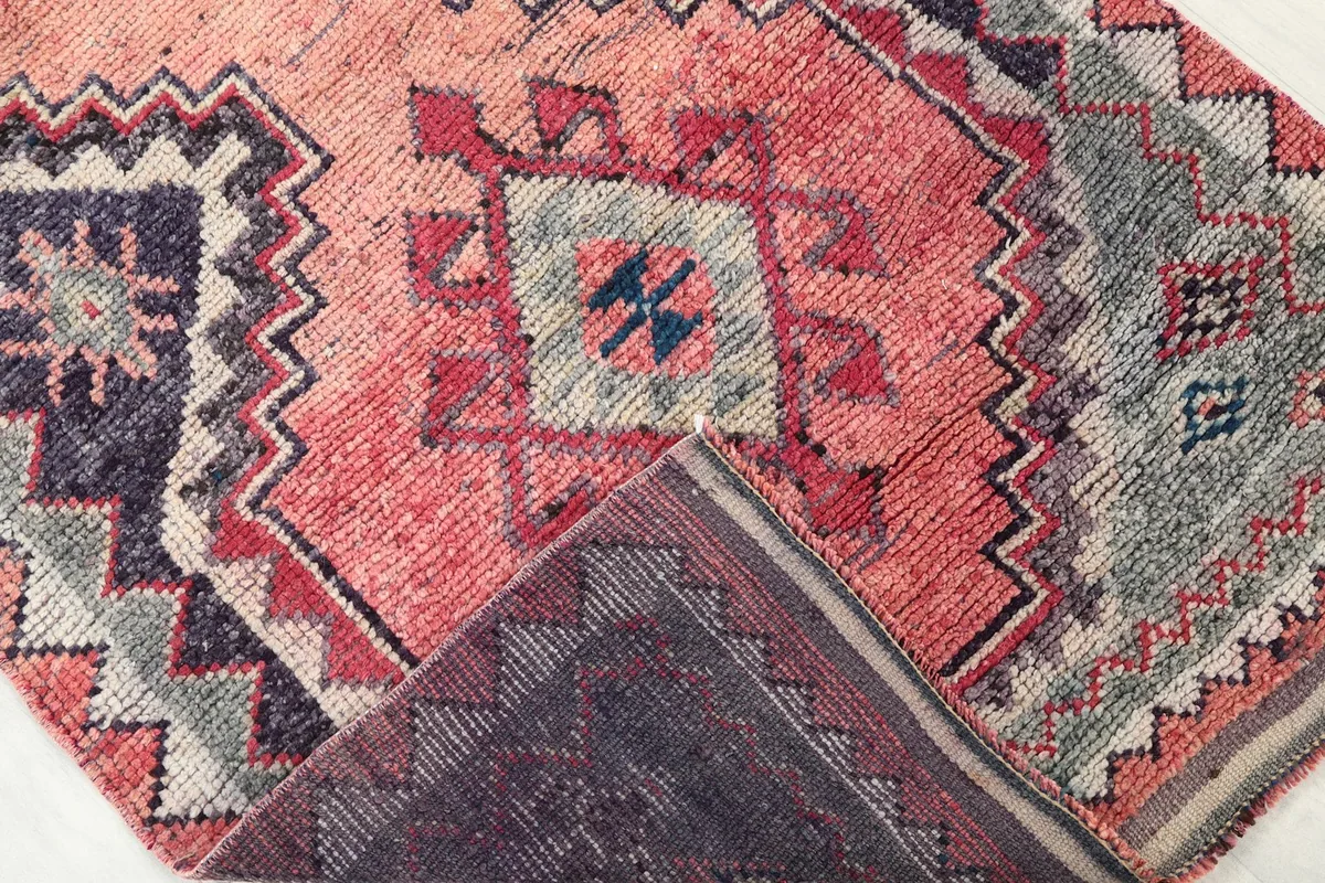 View of the back of the rug, showing the dense hand-knotting and cotton foundation