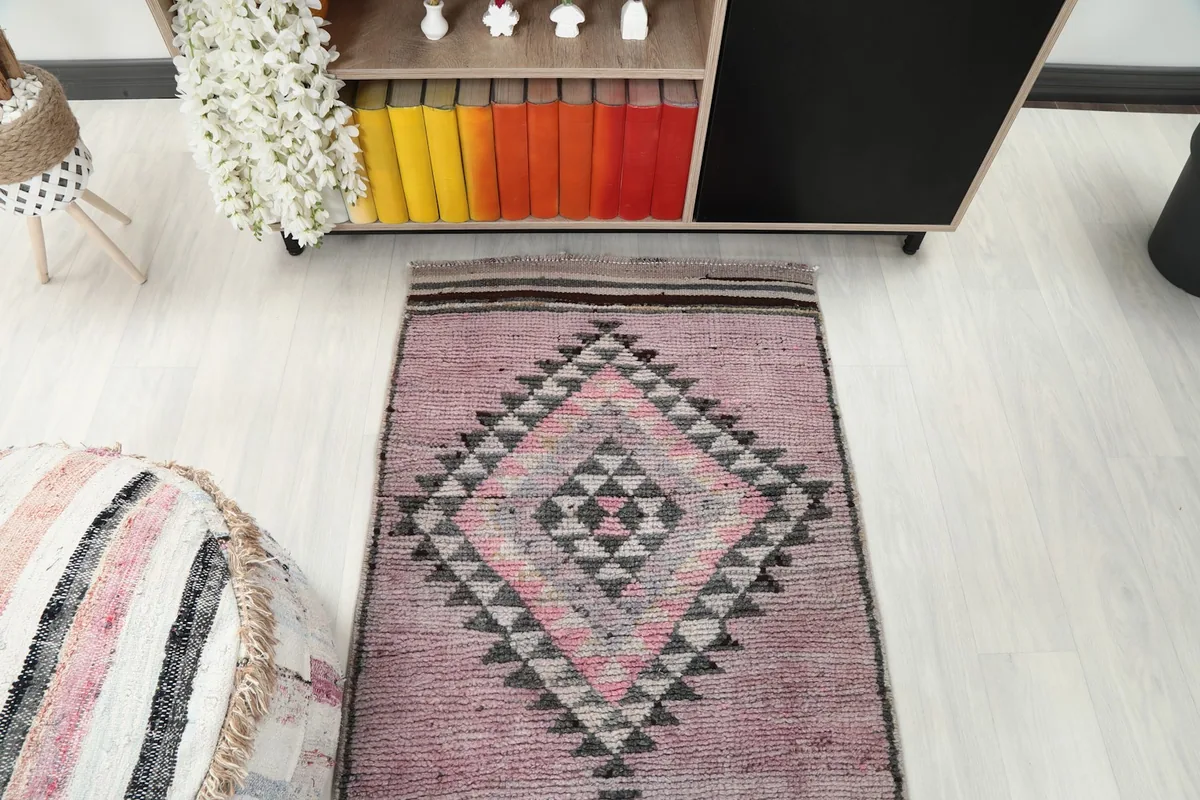 Overhead view of one end of the runner rug in a room, highlighting its geometric design