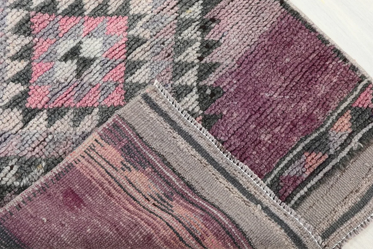 Corner detail showing the front pile and the reverse side of the hand-knotted rug