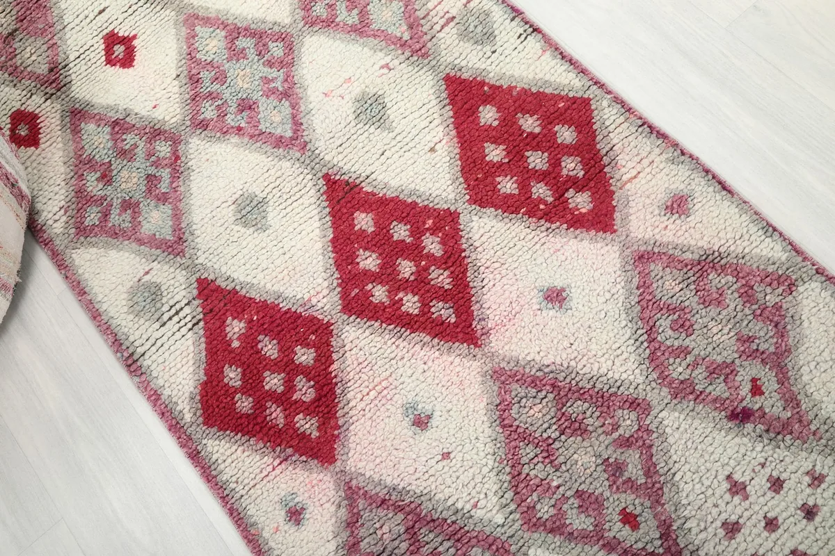 Angled view showcasing the progression of red and purple geometric patterns along the runner