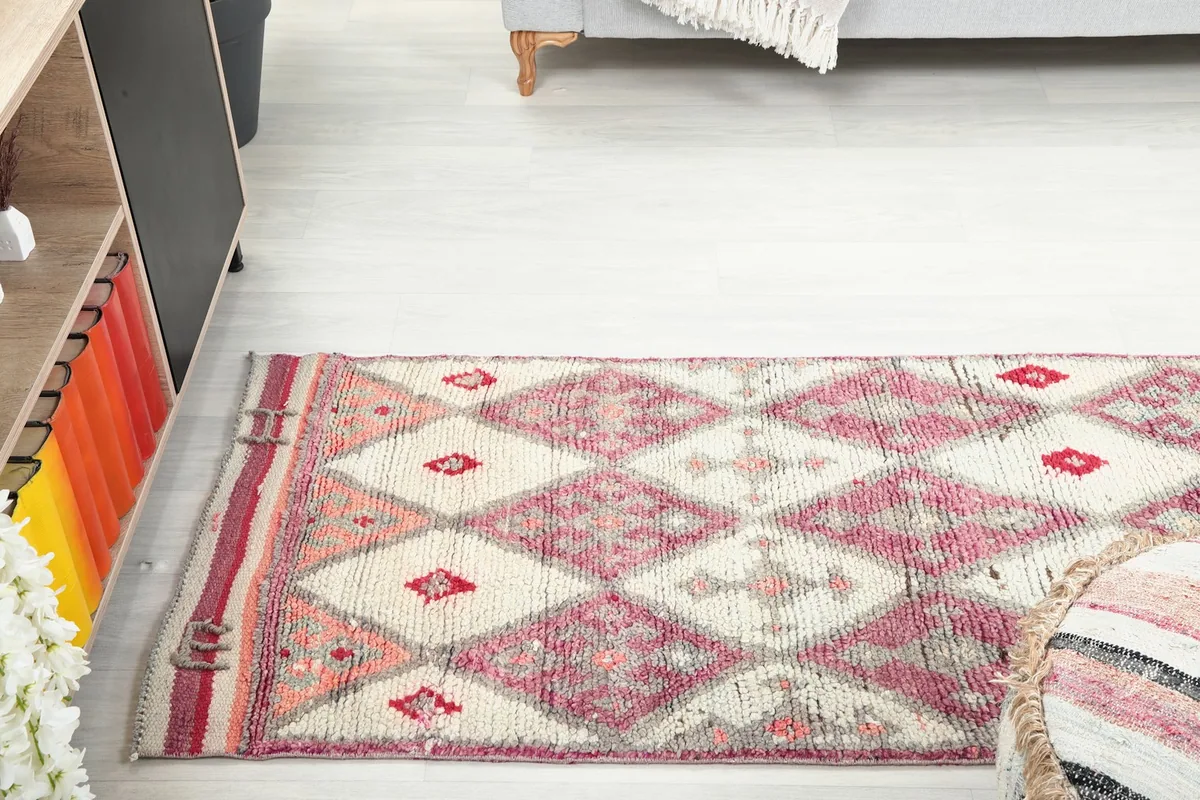 Runner rug extending along a wall, providing a sense of scale in a living space