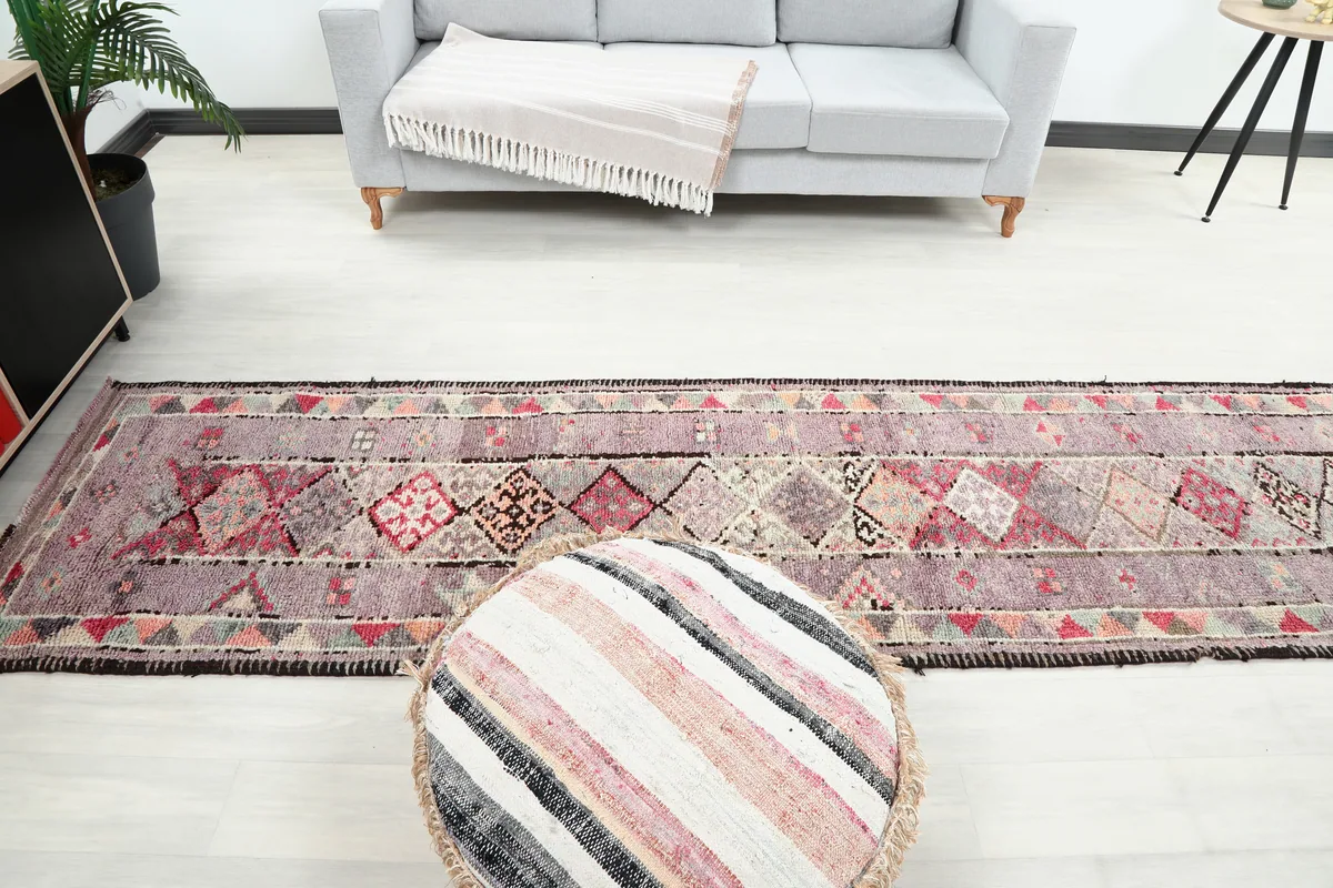 Purple Geometric Anatolian Runner in a living room setup, extending towards a sofa.
