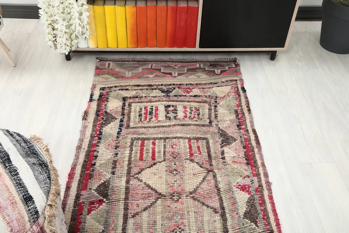 View of the runner rug from one end, showing its placement near furniture in a room