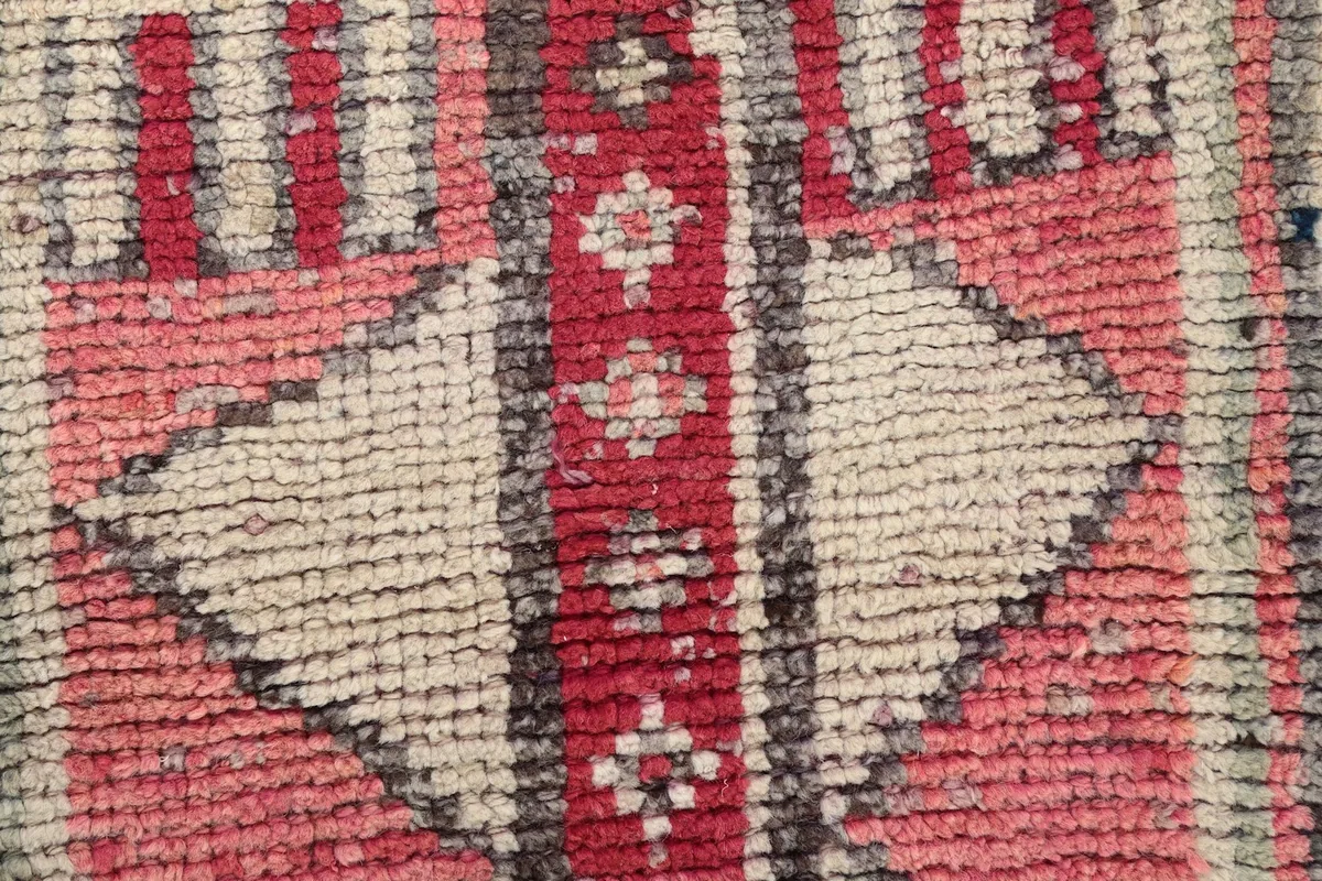 Close-up of the low wool pile, revealing the knotting and color variations