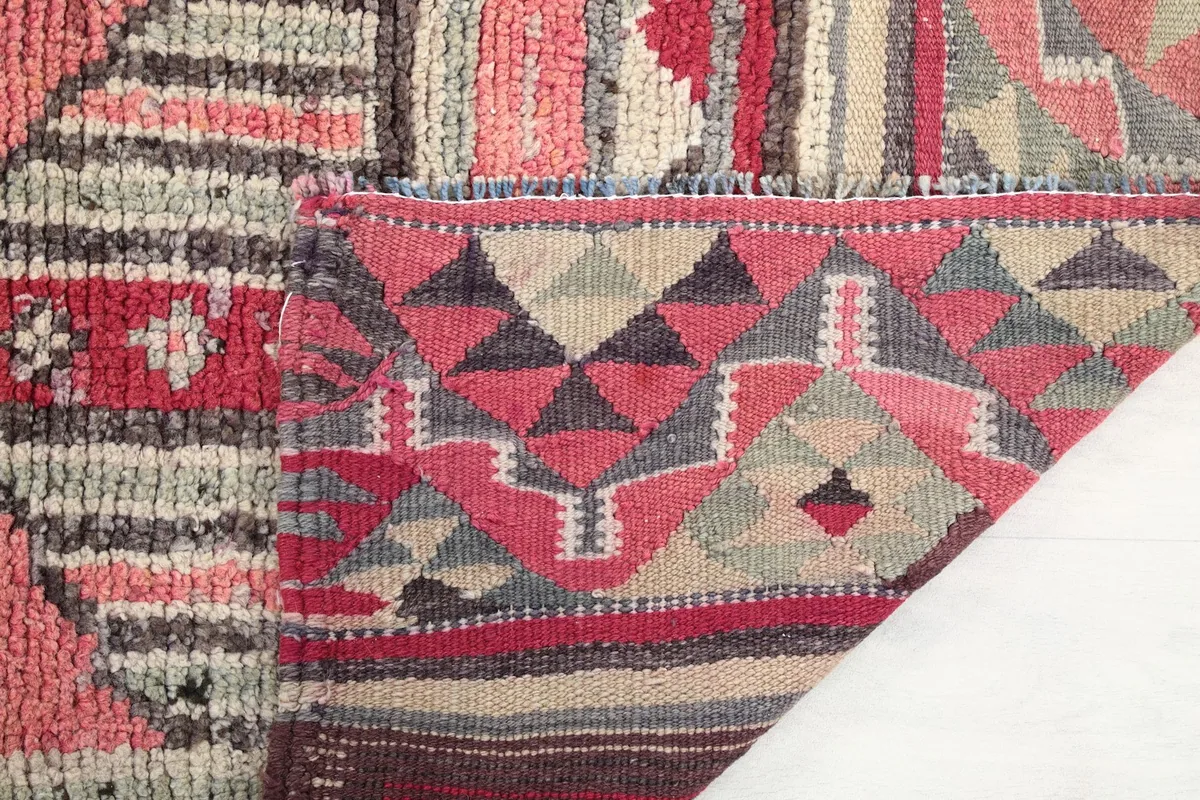 View of the rug's backside, revealing the cotton foundation and hand-knotted construction