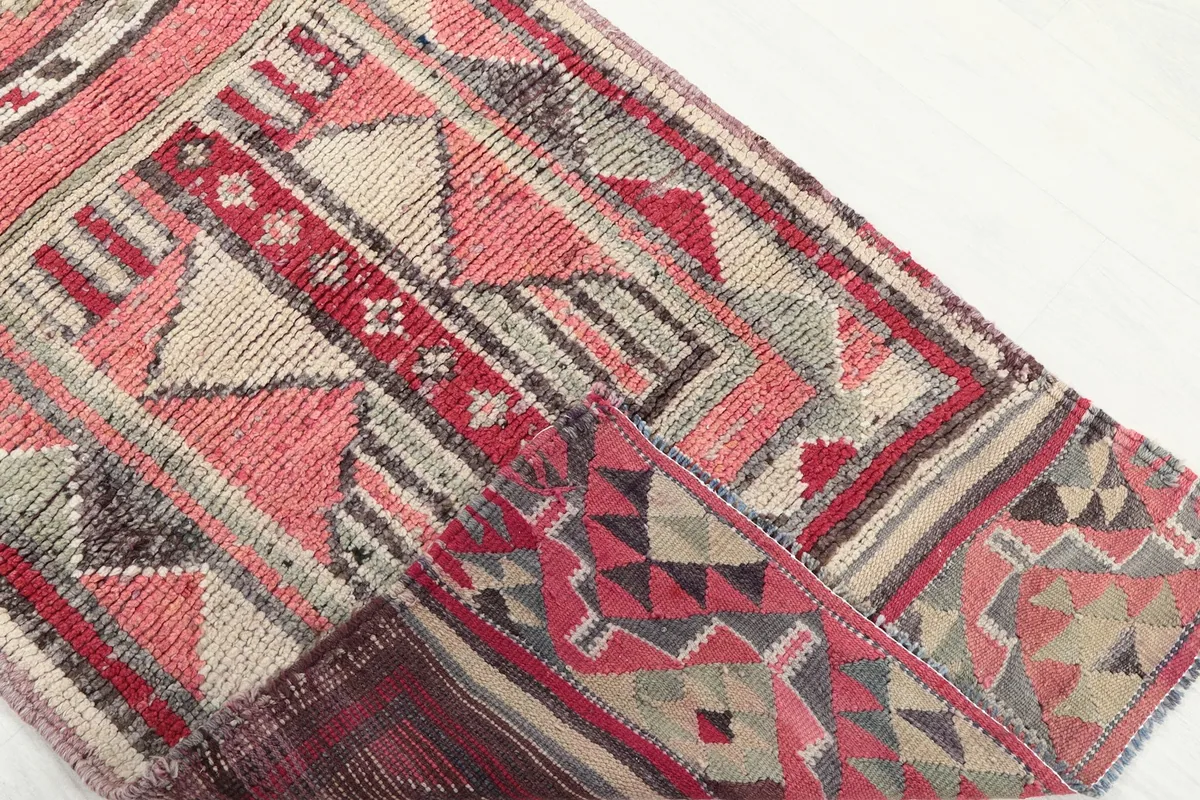 Detail of the rug folded to show the thickness and flexibility of the vintage wool material