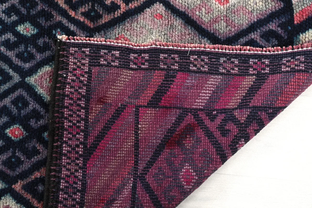 Detailed view of the reverse side of the rug, showing the dense cotton foundation and wool knots