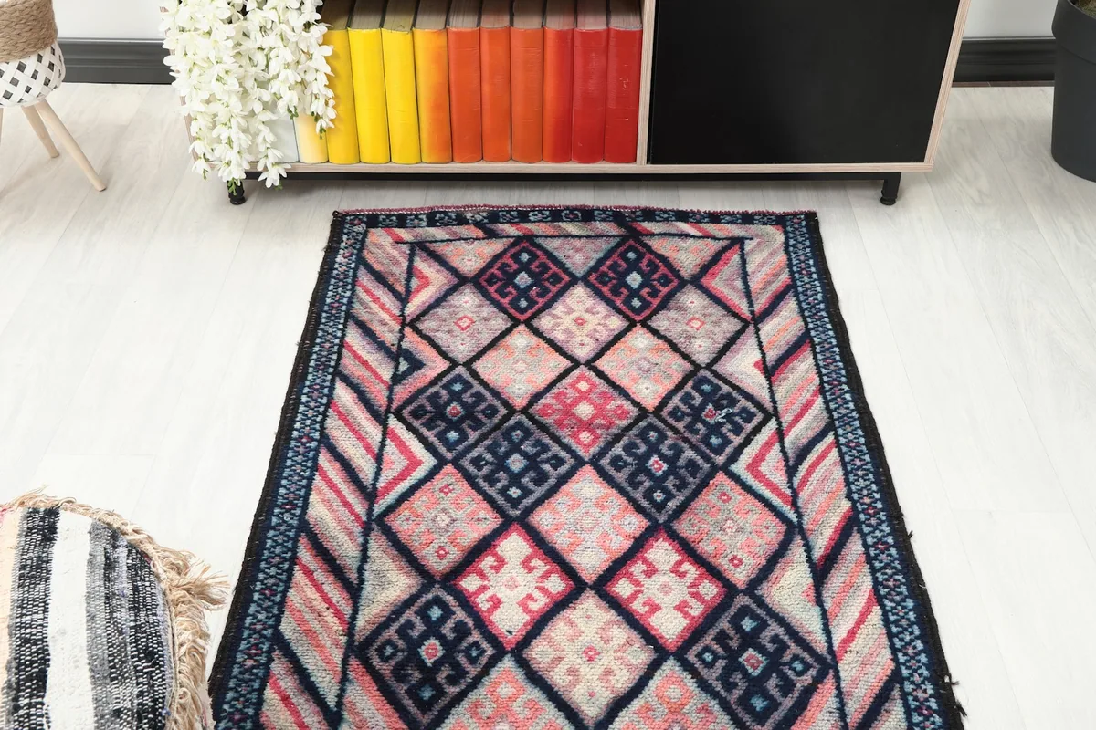 Overhead view of the runner rug's design, positioned in a room with a colorful bookshelf