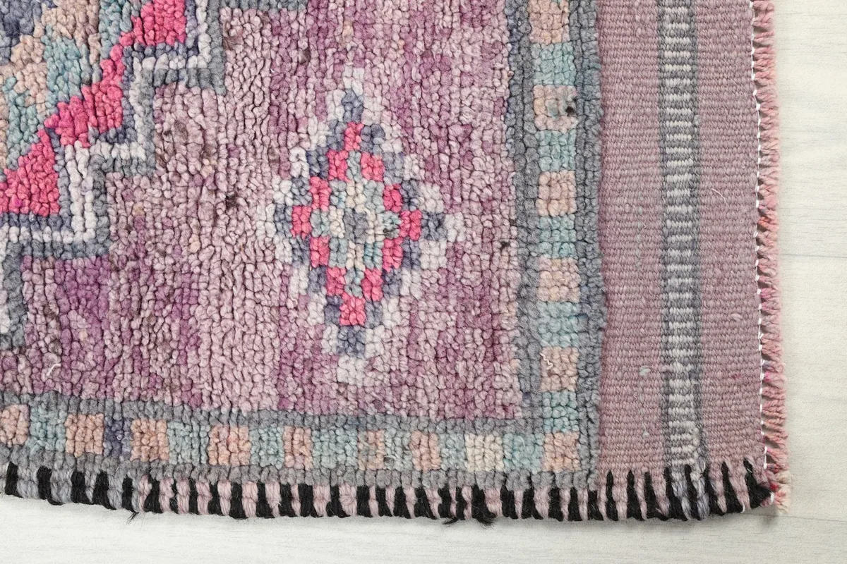 Detailed view of the end border and fringe, showing the hand-knotted texture and colors