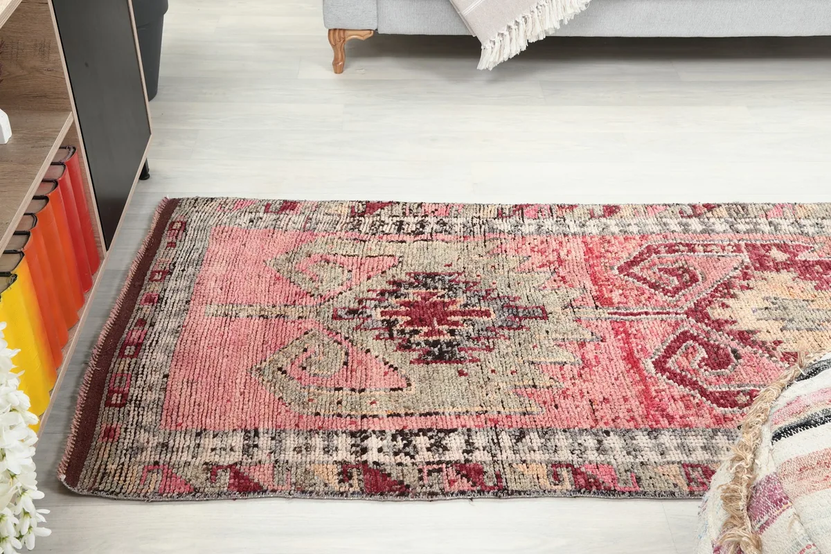 View of the runner rug extending across a room, showcasing its length and vibrant colors.