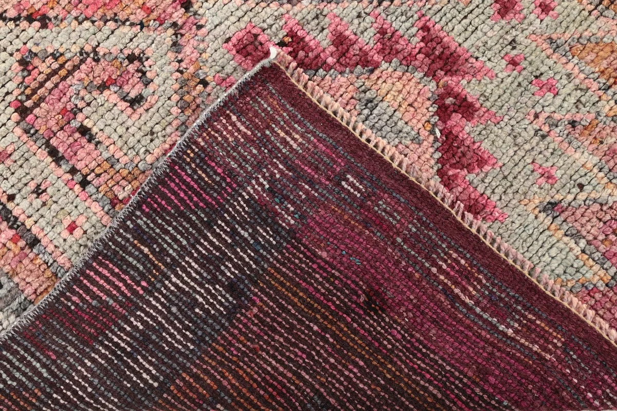 View of the back of the rug, showing the cotton foundation and the reverse of the knots.