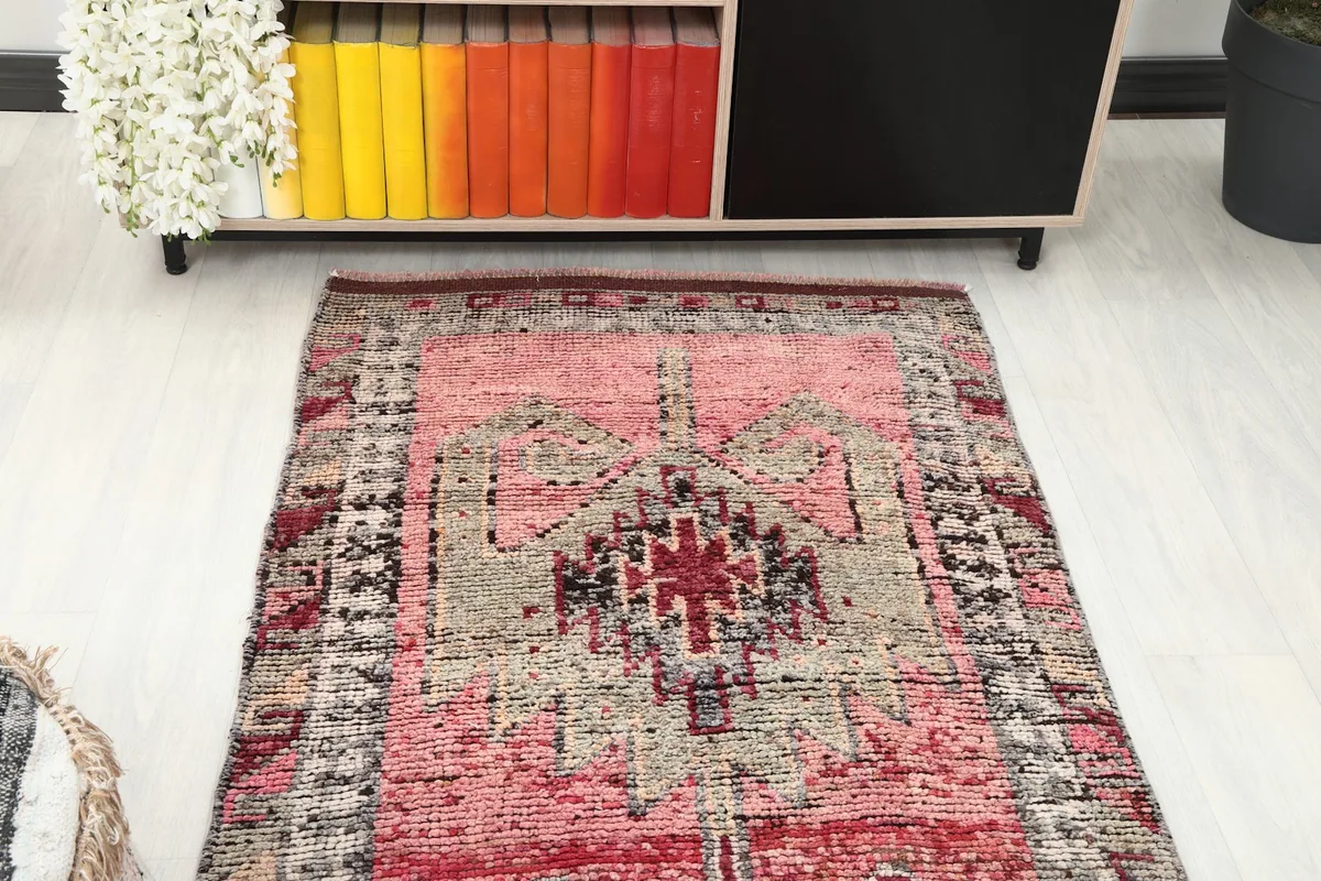 Overhead view of one end of the runner rug in a room, showing the design transition.