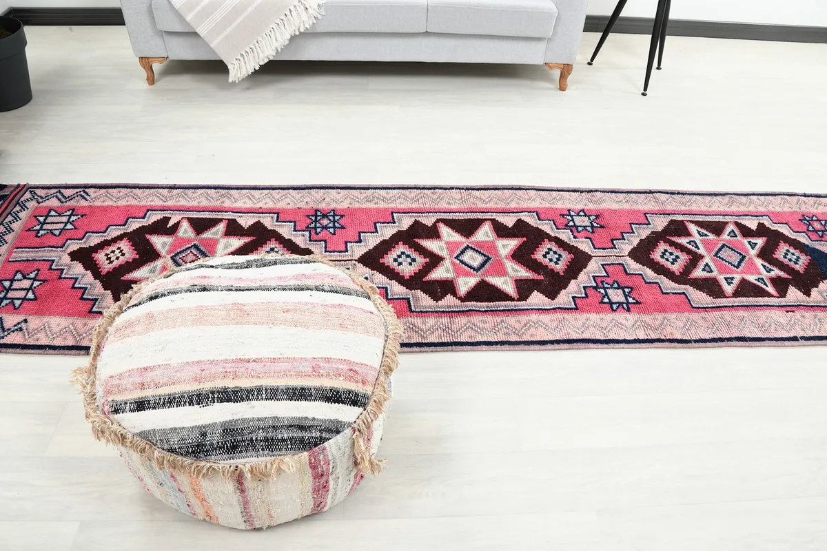 Overhead view of the runner rug with a round ottoman in a minimalist room