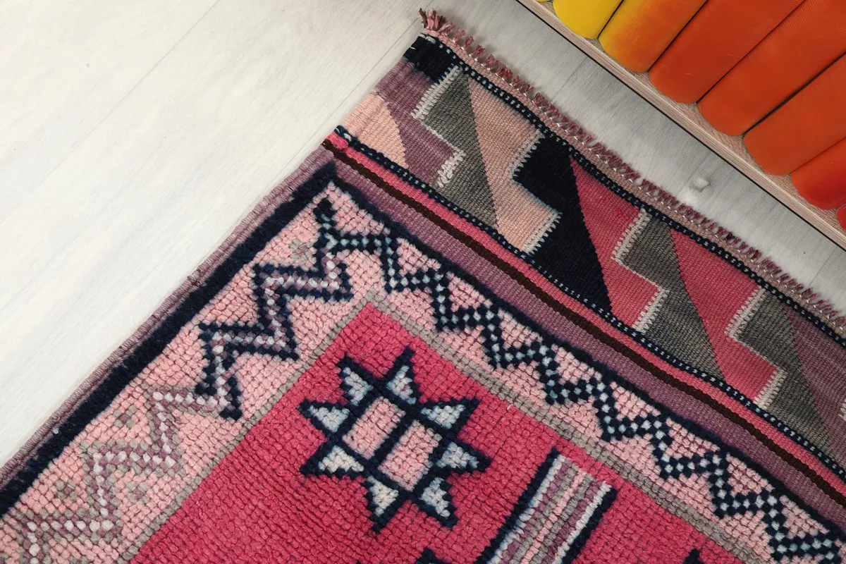 Close-up of the rug's border and end patterns, showing the weave and color variations