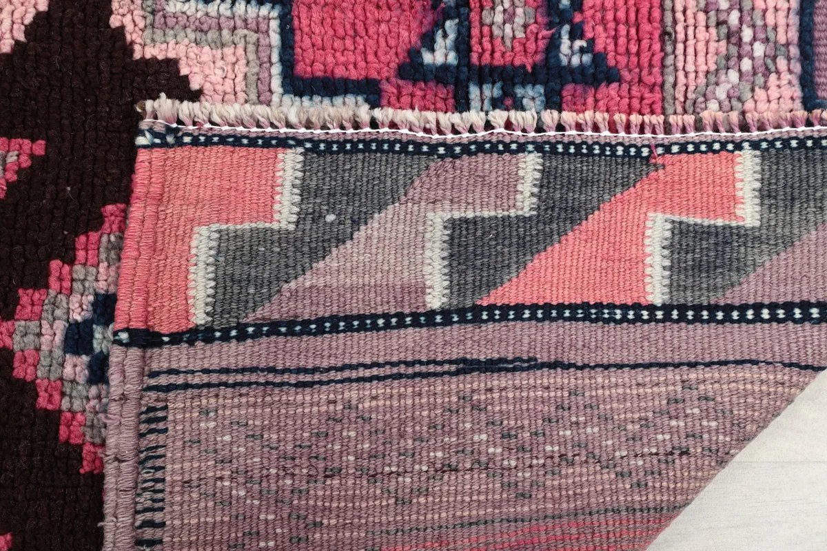 Close-up of the rug's pile and the tightly woven back, revealing its craftsmanship