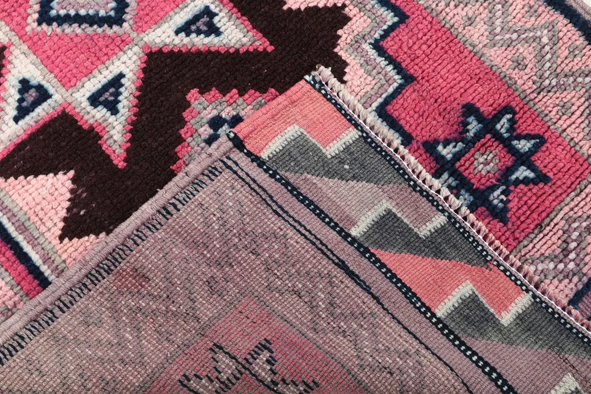 View of the rug's backside, showing the cotton foundation and hand-knotted construction
