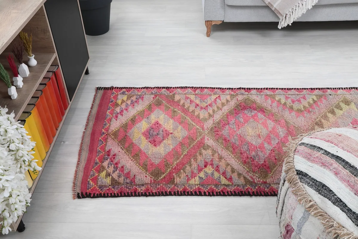 Overhead view of a section of the runner rug in a room, emphasizing its geometric design