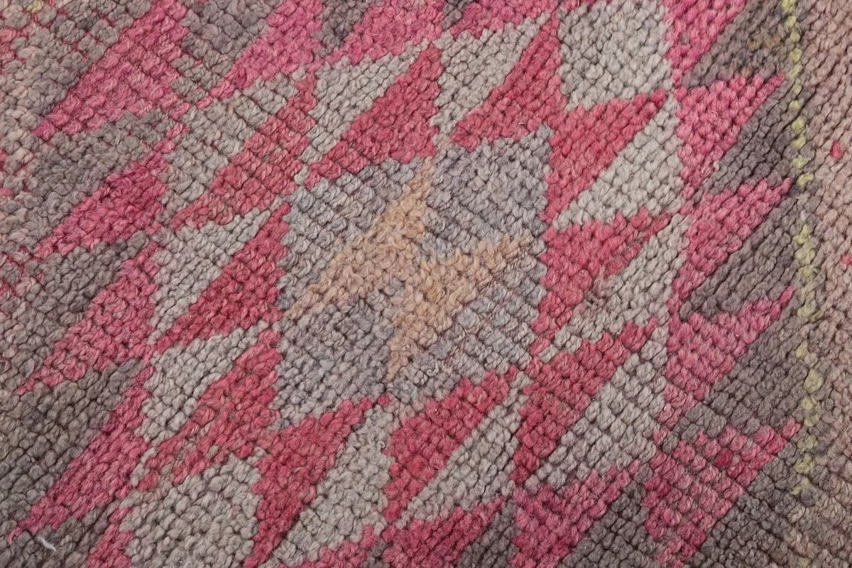 Close-up of the low wool pile texture, highlighting the color variations and hand-knotted knots