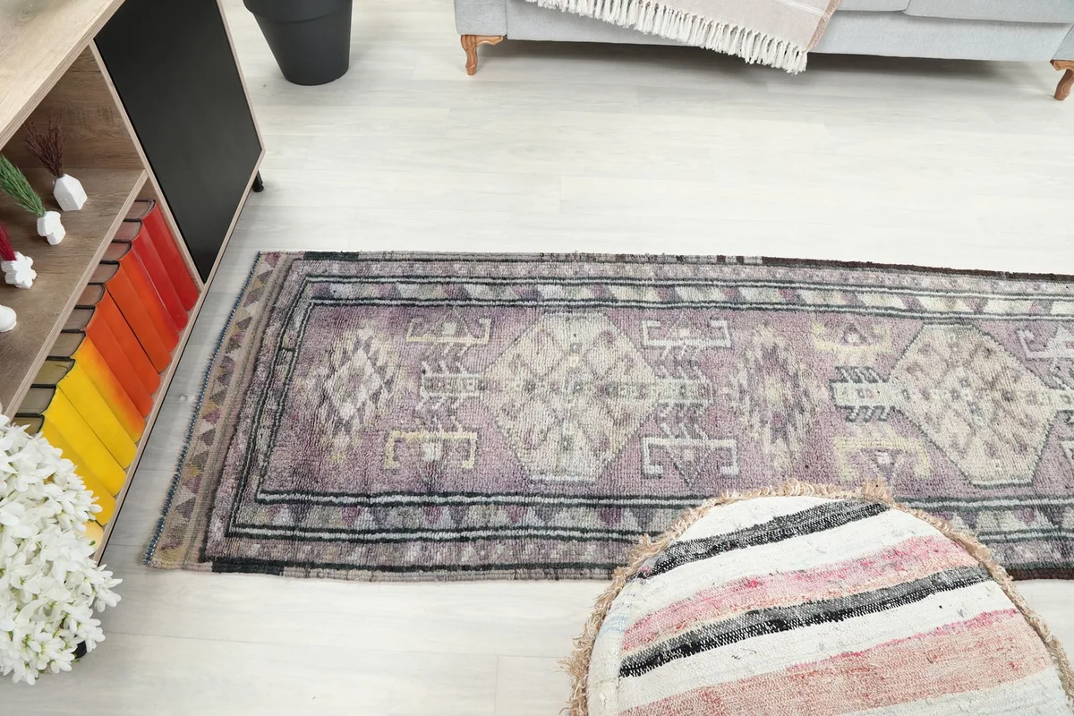 View of the runner rug from above, extending along the floor in a room setting