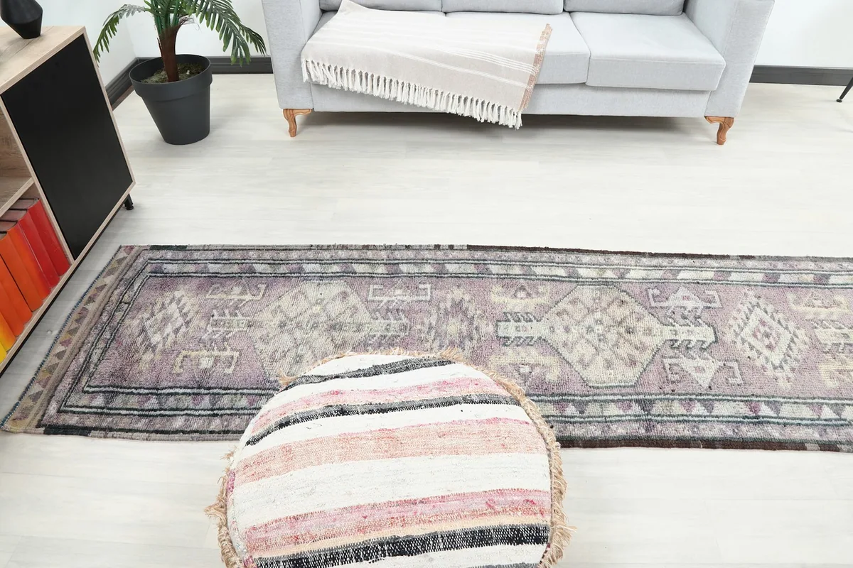 Wide shot of the vintage runner rug in a room, showing its full length and placement