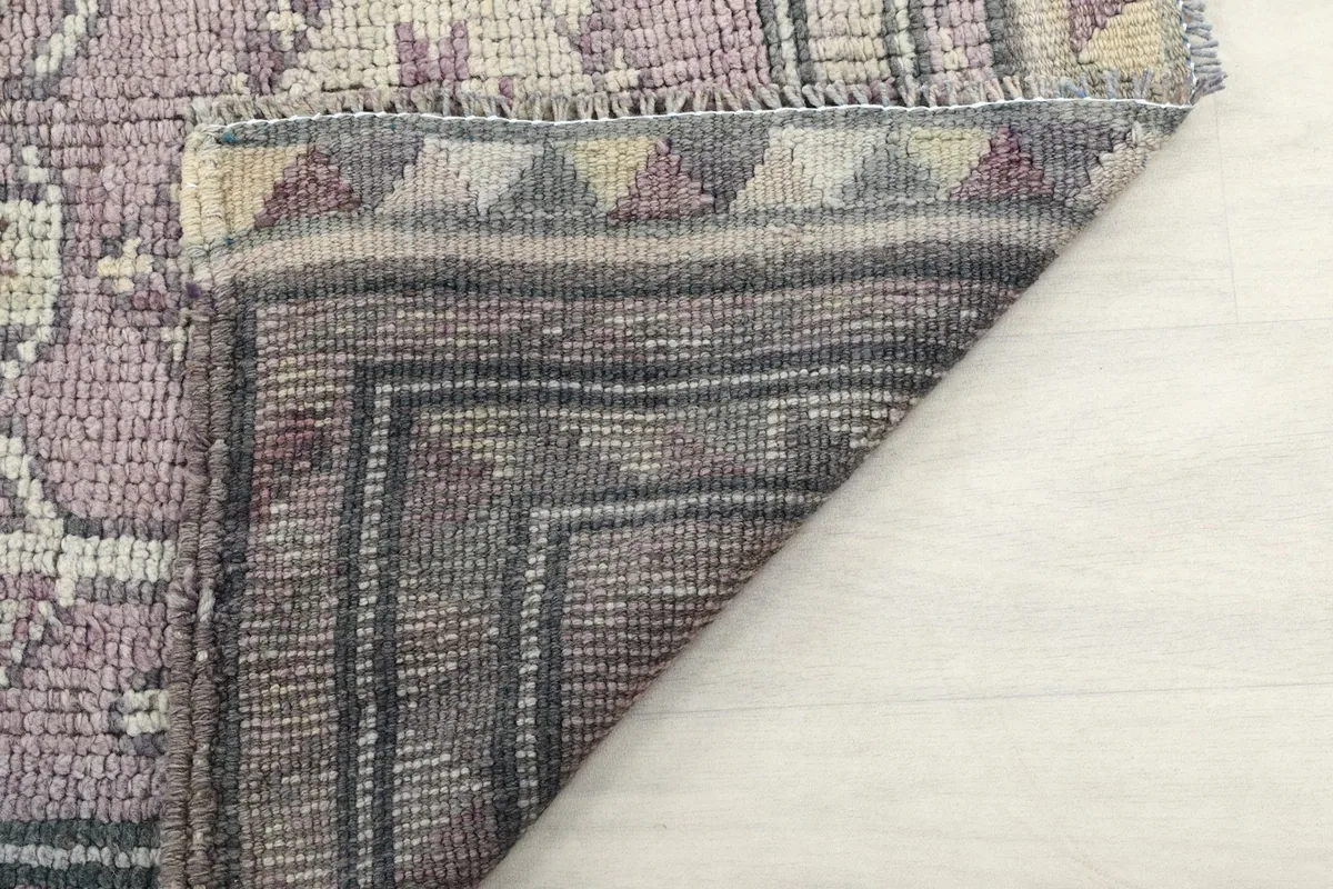 Underside view of the rug, showing the cotton foundation and hand-knotted construction
