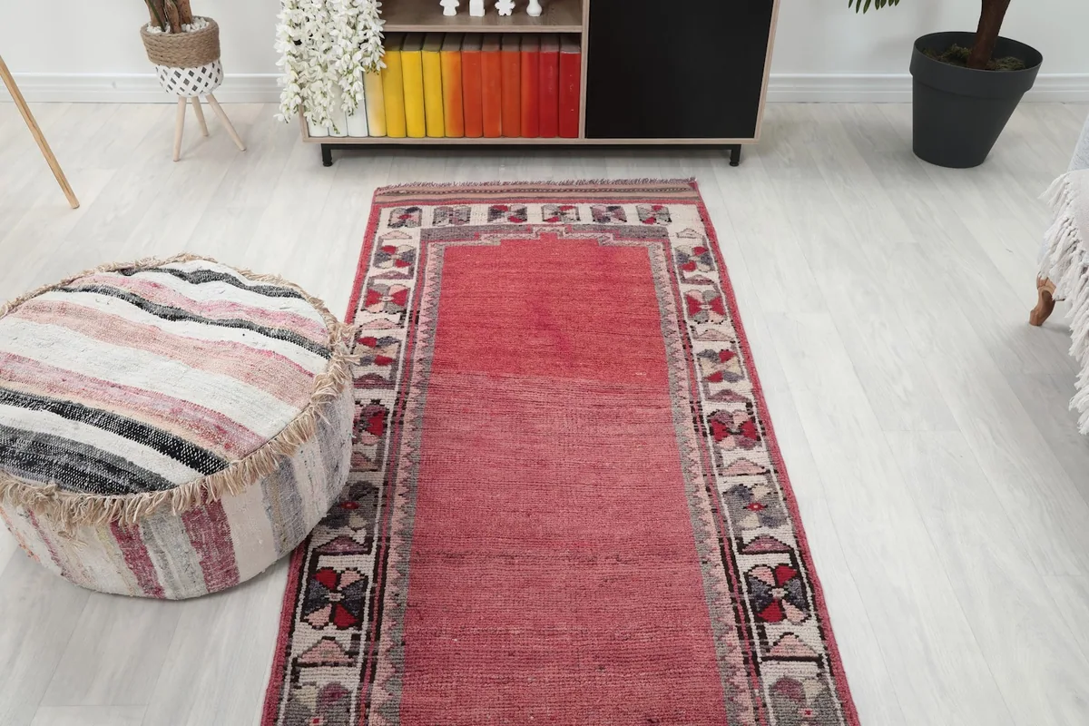 Overhead perspective of the rose runner rug in a room, showing its full length