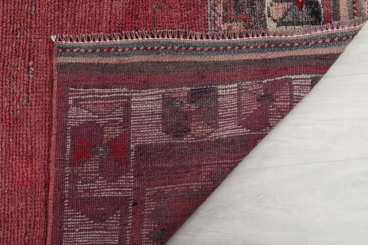 Close-up of the back of the rug, showing the knotting structure and fringe