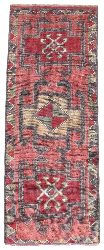 Full top view of the vintage rust tribal geometric runner rug on a white background