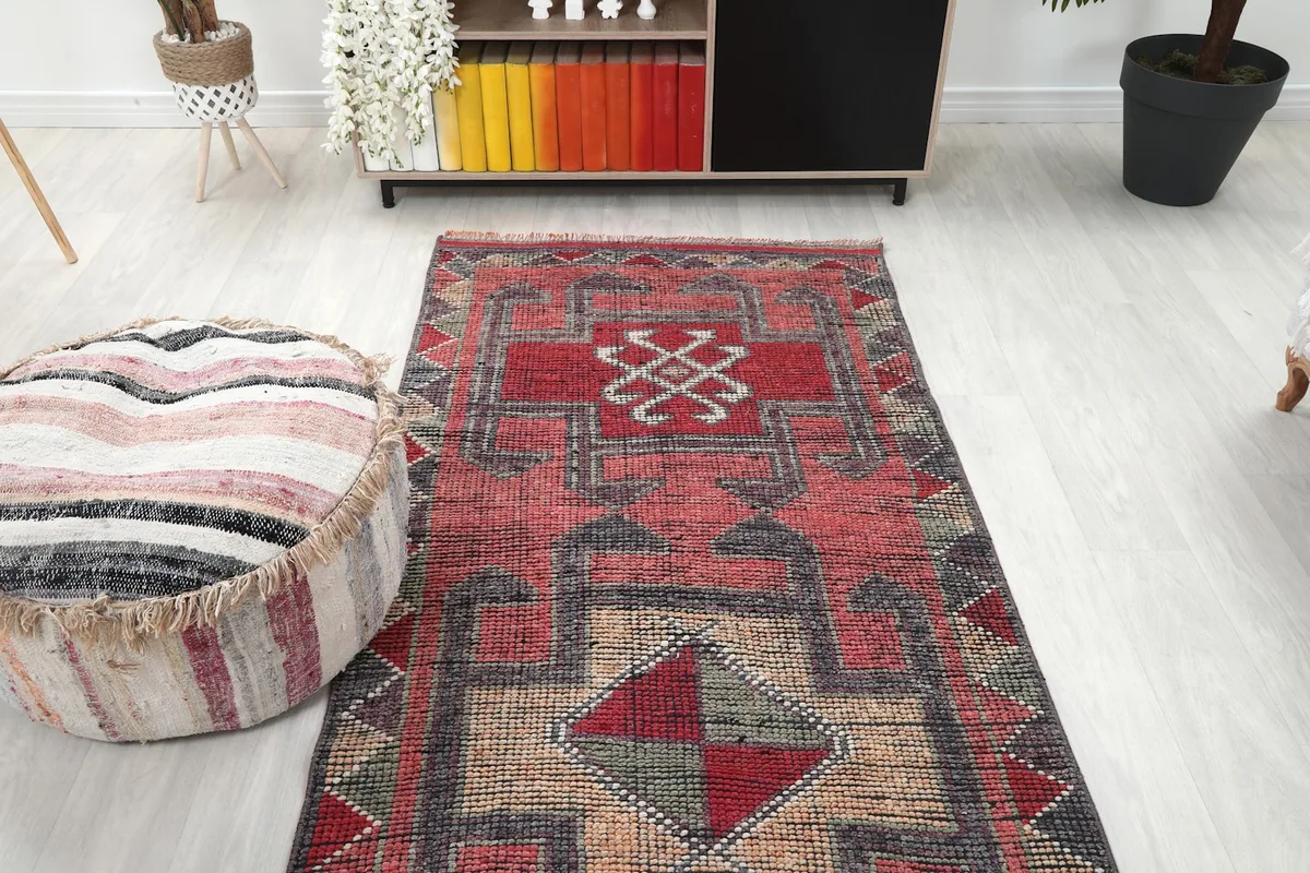 View of the runner rug extending from a bookshelf towards the center of a room