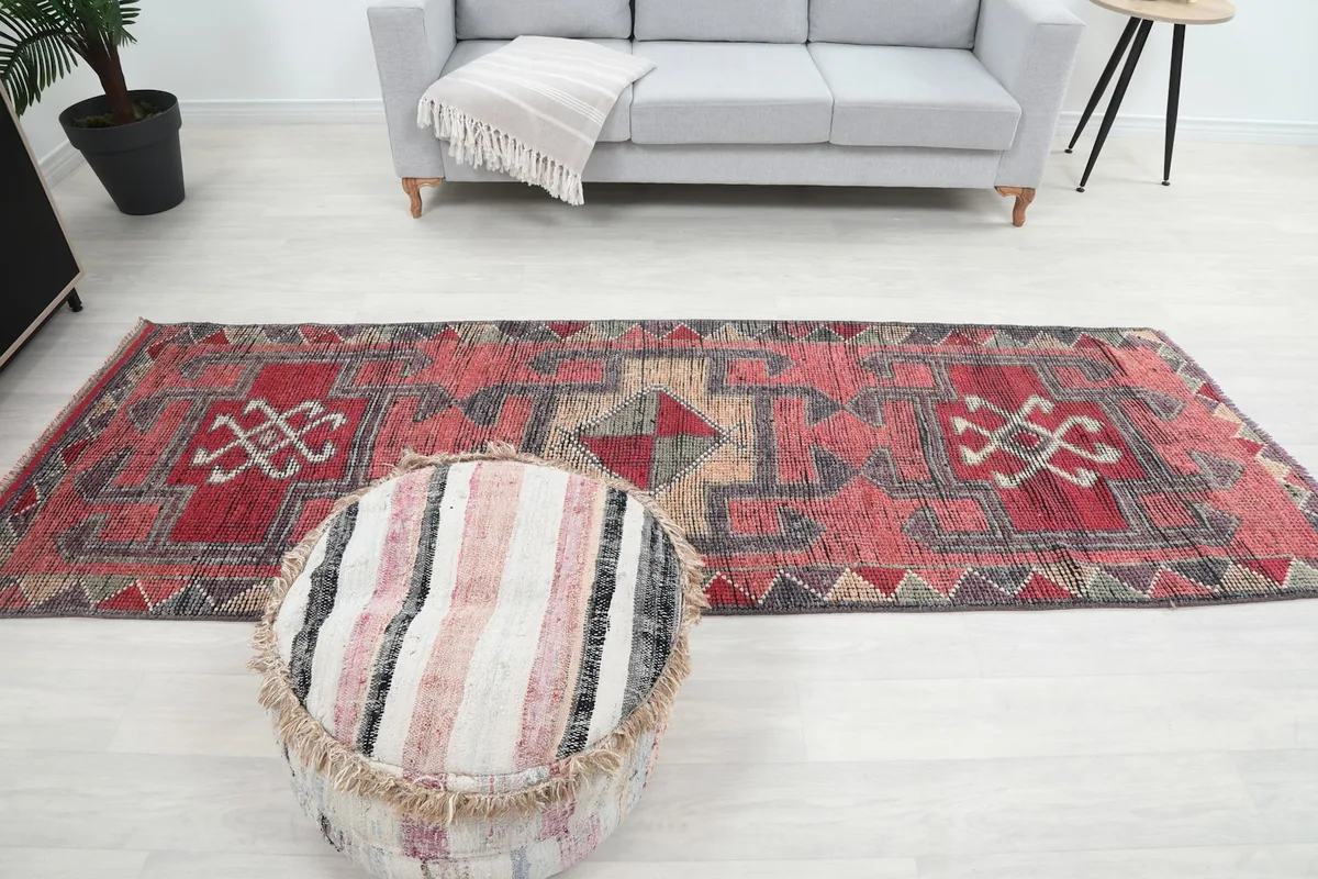 Full overhead view of the rust runner rug in a room, showcasing its elongated shape
