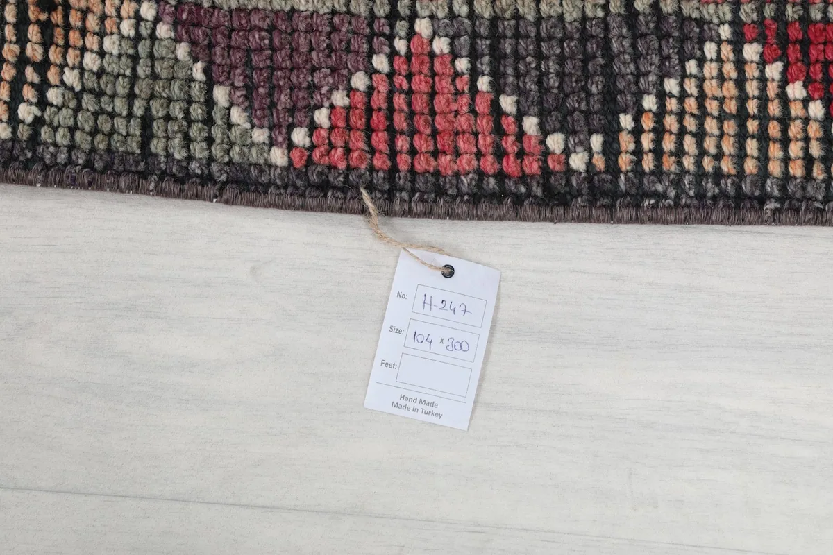 Detail of the product tag attached to the rug, showing size and origin