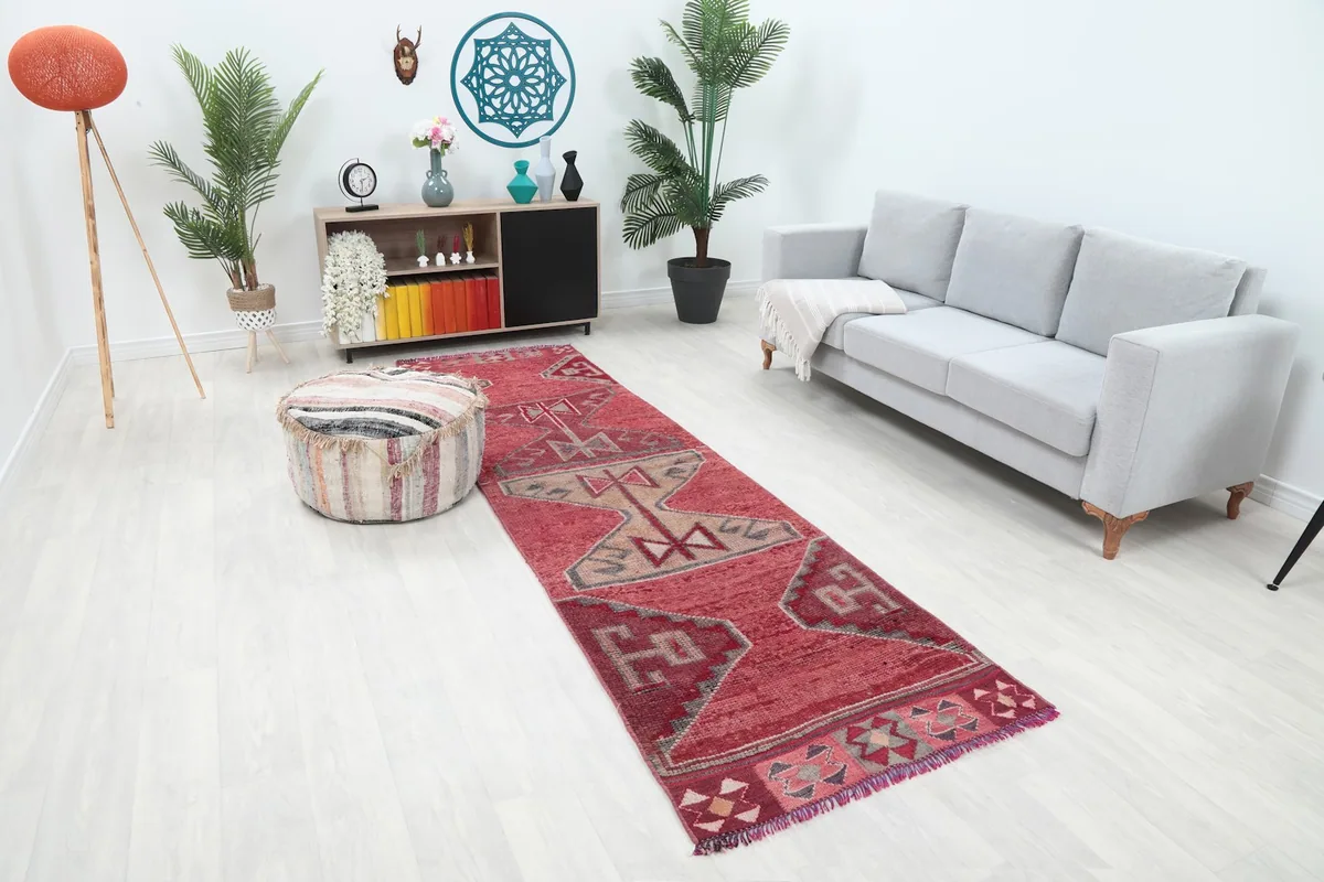 Angle view of the Rose Tribal Anatolian runner rug in a living room, showcasing its length