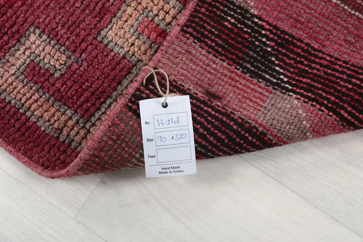 Close-up of the rug's label attached to the back, indicating hand-made in Turkey