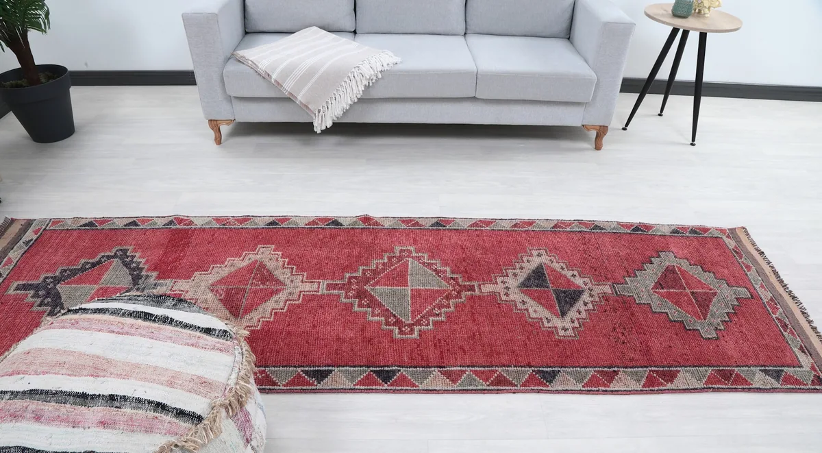 Full overhead view of the red runner rug in a staged room, showing its complete design